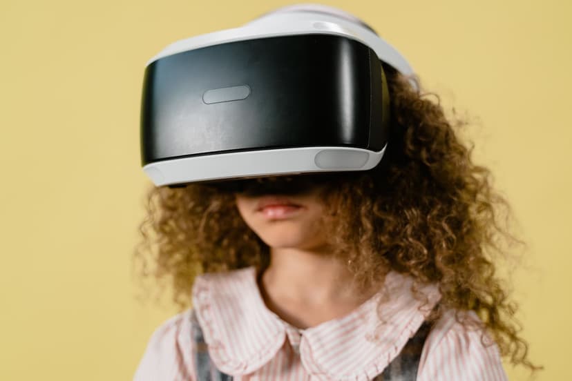 A young girl wearing a virtual reality headset, immersed in a digital experience, with a look of excitement on her face.