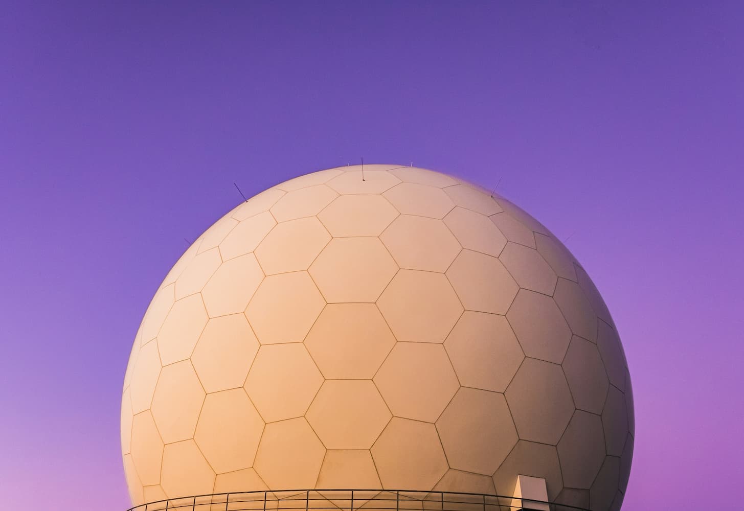 A large white egg-shaped structure against a vibrant purple sky.