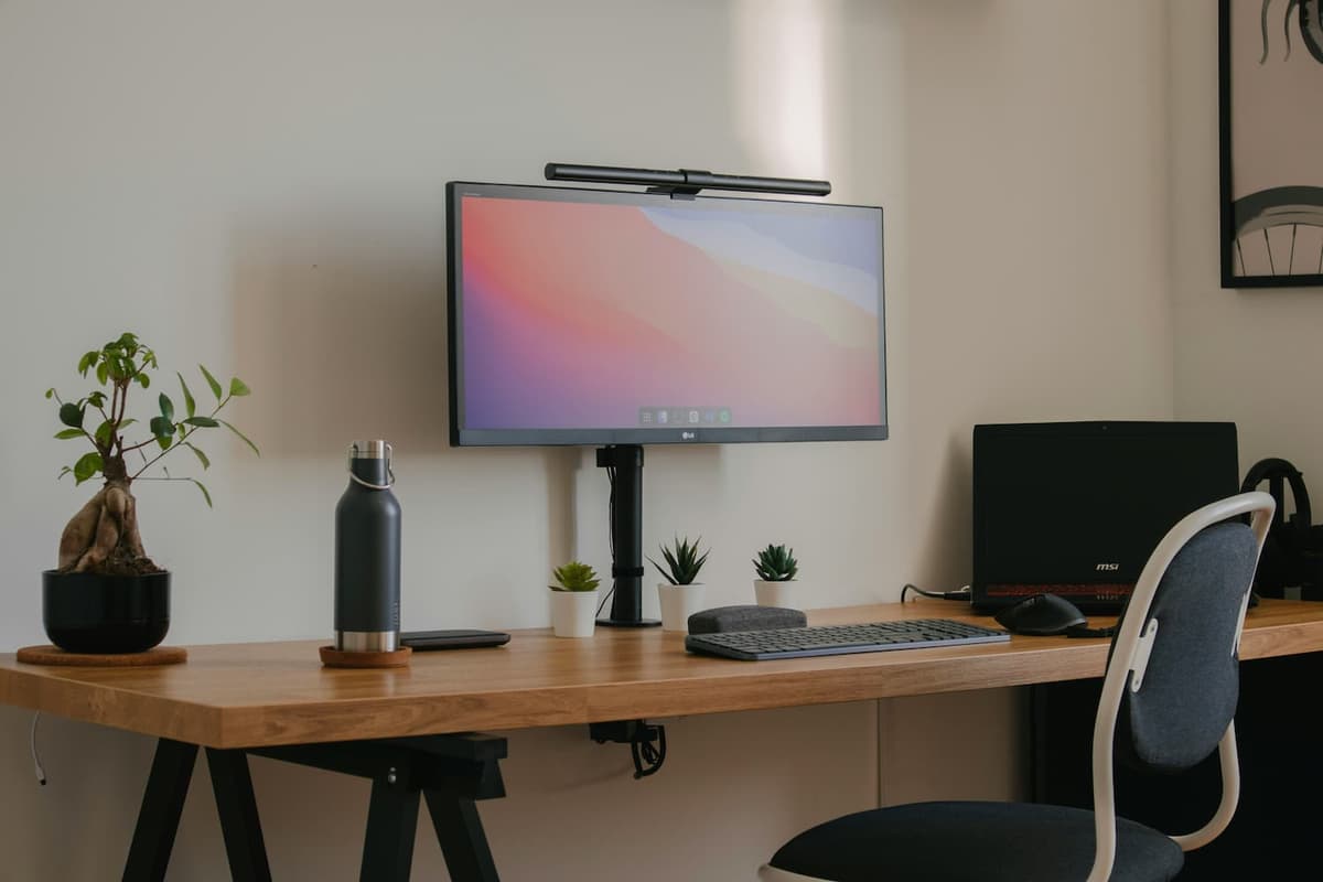 A desk featuring a computer monitor and an office chair, creating a workspace setup.